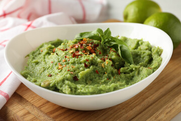 Bowl with guacamole, spices and basil, close up