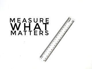 Measure what matters quote with a ruler on white background.