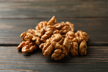 Heap of tasty walnuts on wooden background