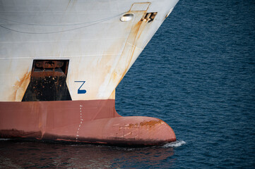 detail of the bow bulb of a ship sailing through the sea