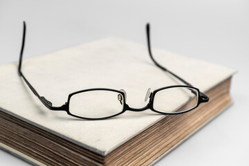 Old antique book with glasses.