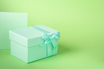 Green box with gift bow and card with space on the right to write what you want
