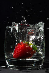 strawberries in a glass of water in bubbles