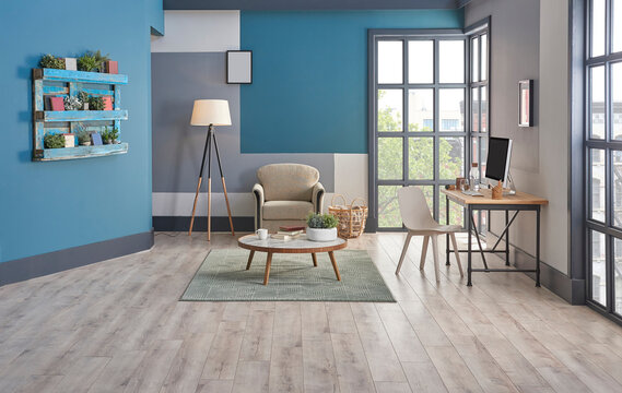 Decorative blue and grey wall background, home decoration interior style with sofa carpet middle table frame and working desk style.