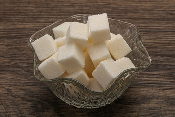 Refined white sugar cubs in the bowl