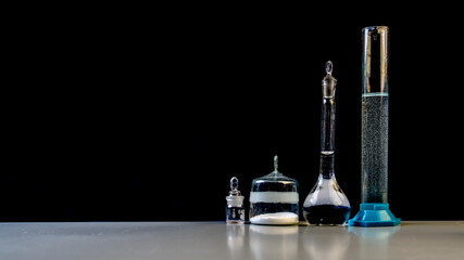 medical laboratory glass and flasks on black background