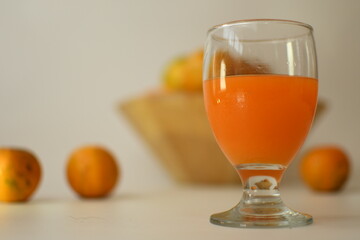 orange juice with fruits in the wooden bowl white background