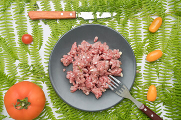 Minced meat to make almond beans. Green background, no people