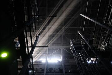 Almaty, Kazakhstan - 02.04.2021 : The light of the sun shines through the metal structures on the heating plant.