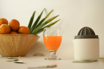 orange juice with fruits in the wooden bowl white background