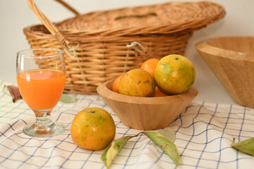 orange juice with fruits in the wooden bowl white background