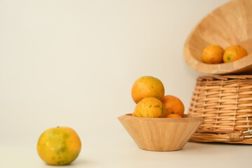 orange juice with fruits in the wooden bowl white background