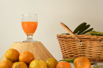 orange juice with fruits in the wooden bowl white background