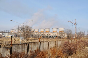 Almaty, Kazakhstan - 02.04.2021 : Fenced territory of the heating plant with old blocks and barbed wire.