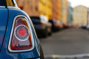 Car back light. Tail Light of a car on the city background