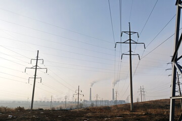Almaty, Kazakhstan - 02.04.2021 : Power lines on the background of the building of the main heating...