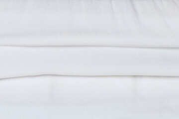 A soft white fabric background.