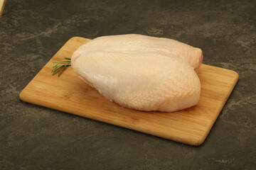 Raw whole chicken breast with skin