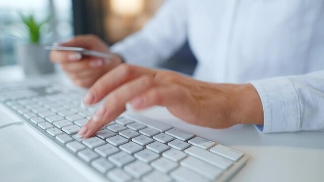 Female hands typing credit card number on computer keyboard. Woman making online purchase. Online payment service.