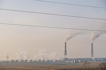 Almaty, Kazakhstan - 02.04.2021 : Territory and building of the heating plant with smoking pipes