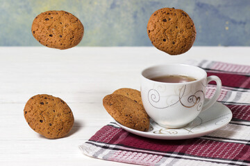 cup of tea with falling cookies