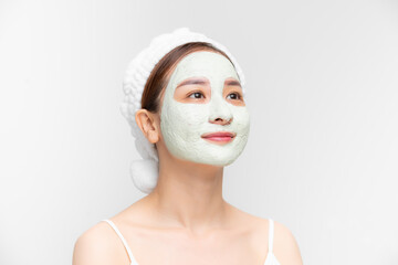 Attraactive young Asian woman with a face clay mask against acne on the face of a woman to rejuvenate the skin