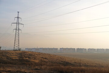 Almaty, Kazakhstan - 02.04.2021 : Power lines on the background of houses covered with a layer of...
