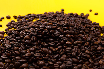 Coffee beans on a yellow background.