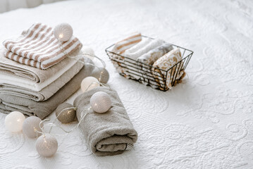 Laundry, towels folded and rolled in baskets in bedroom. Concept of tidiness, minimalism lifestyle and japanese folding system. Organizing wardrobe, stuff in boxes