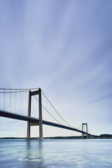 a long bridge with blue water
