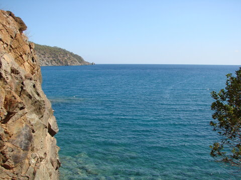 Unsurpassed natural picture of the azure surface of the calm sea on a background of clear blue sky.