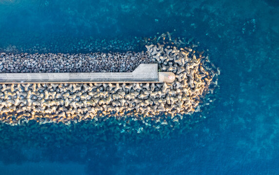 Aerial view of the breakwater at St. Mateus harbour on Terceira island. Azores archipelagos, Portugal.