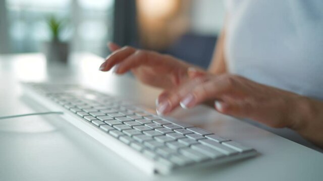 Accelerated video of female hands typing on a computer keyboard. Concept of remote work. Quick motion. Timelapse