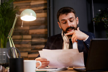 Young businessman working on laptop at office. Businessman sitting at office desk working on new project