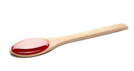 Blackcurrant fruit nectar, juice puddle with wooden spoon isolated on white background