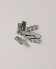 staple clips. paper clips for stapler on white background top view