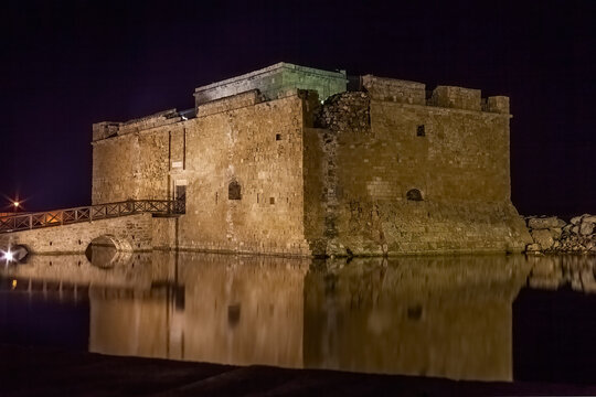 Paphos Castle in Cyprus at night which is now a museum in the harbour and is a popular tourist travel destination attraction landmark of the Mediterranean island, stock photo image