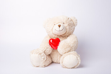 teddy bear holding heart isolated on white background