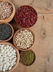 assortment of beans on wooden surface