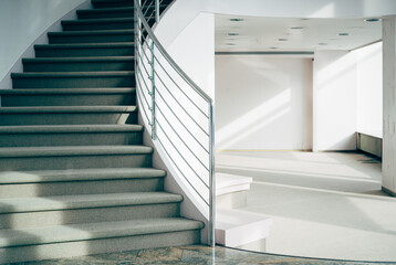 sunlight filled empty modern room with staircase