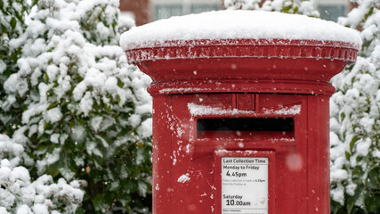 Close up of a Red post box in the snow at Christmas	
