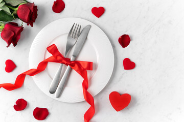 Plate with red rose for Valentine's Day dating meal concept.