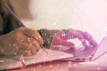 Double exposure of businesswoman hands typing on computer and forex chart hologram drawing. Financial analysis concept.