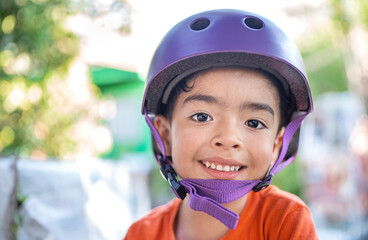 Fototapeta na wymiar boy with violet helmet smiles and background with background