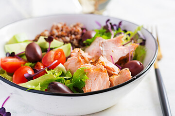 Salmon salad. Fresh salad with grilled salmon, avocado, cherry tomatoes, lettuce, quinoa, olive and microgreens. Homemade food. Concept healthy meal