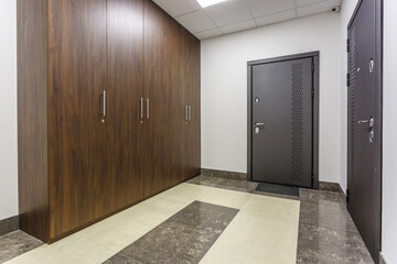 empty corridor for room in interior of modern apartments, office or clinic with many metal doors