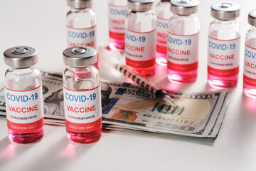 New coronavirus COVID19 infection vaccine with dollar bills and syringe on white background
