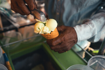 Ice cream cone,Ice cream in hand during the hot day