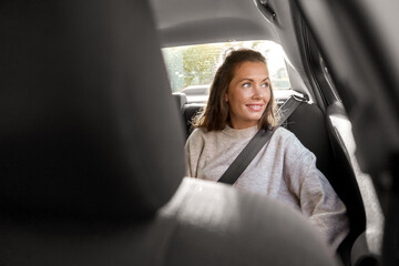 transport, vehicle and people concept - happy smiling woman or female passenger in taxi car