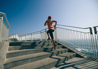 healthy lifestyle fitness sports woman runner running on seaside trail